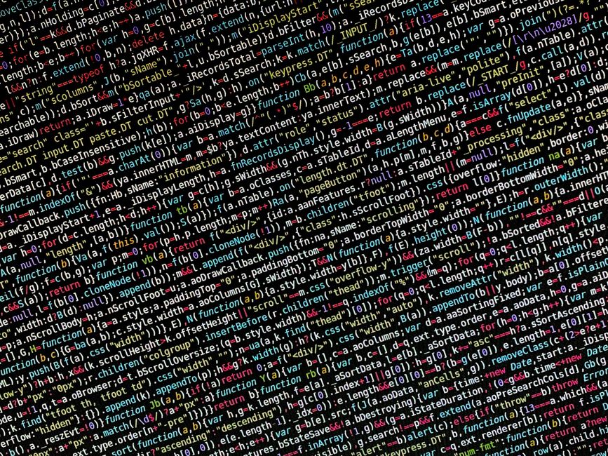 Close-up of a computer screen displaying lines of syntax-highlighted HTML code, with elements such as tags, attributes, and image file references. The code is multicolored, including shades of blue, y